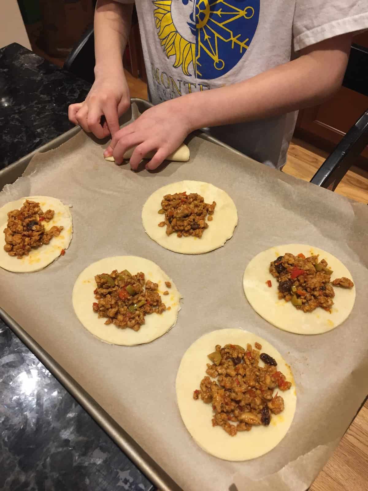 empanadas ready to be folded and sealed.