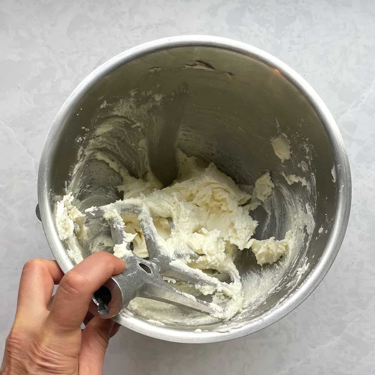 mixing bowl with paddle in creamed butter and sugar mixture.