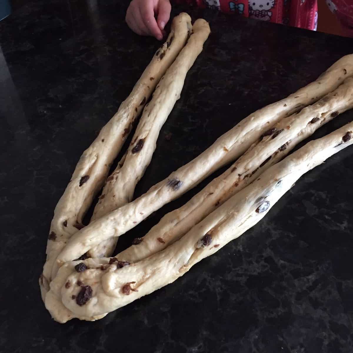 second step in the braiding of the raisin challah.