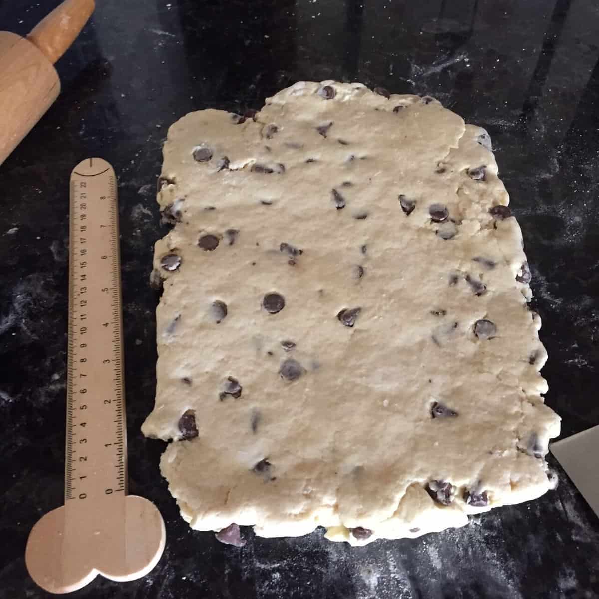 rolled out chocolate chip scone dough next to baking ruler.