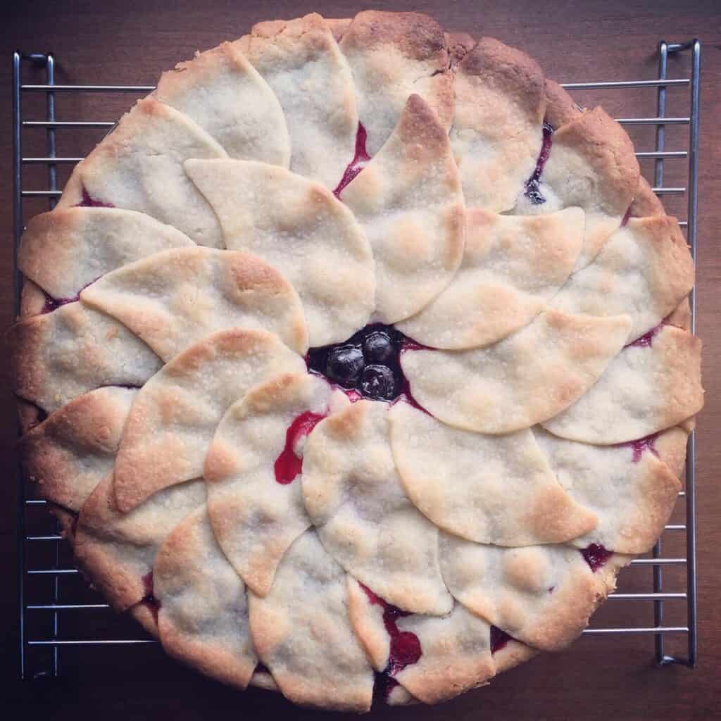 a baked pie covered with a top crust of individual petal cut outs