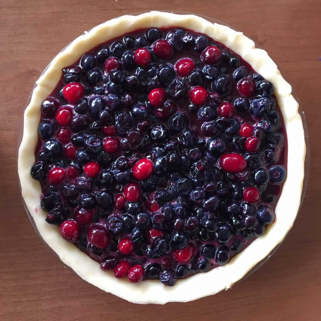 the open face of a blackberry and cranberry pie