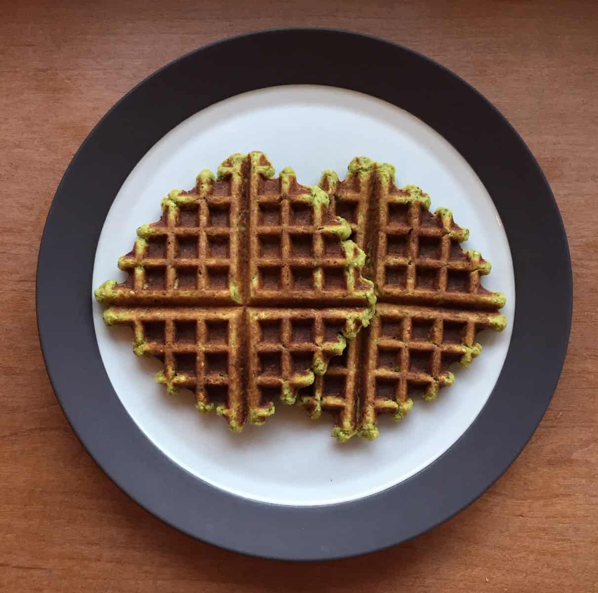 A plate with two waffles made from falafel batter