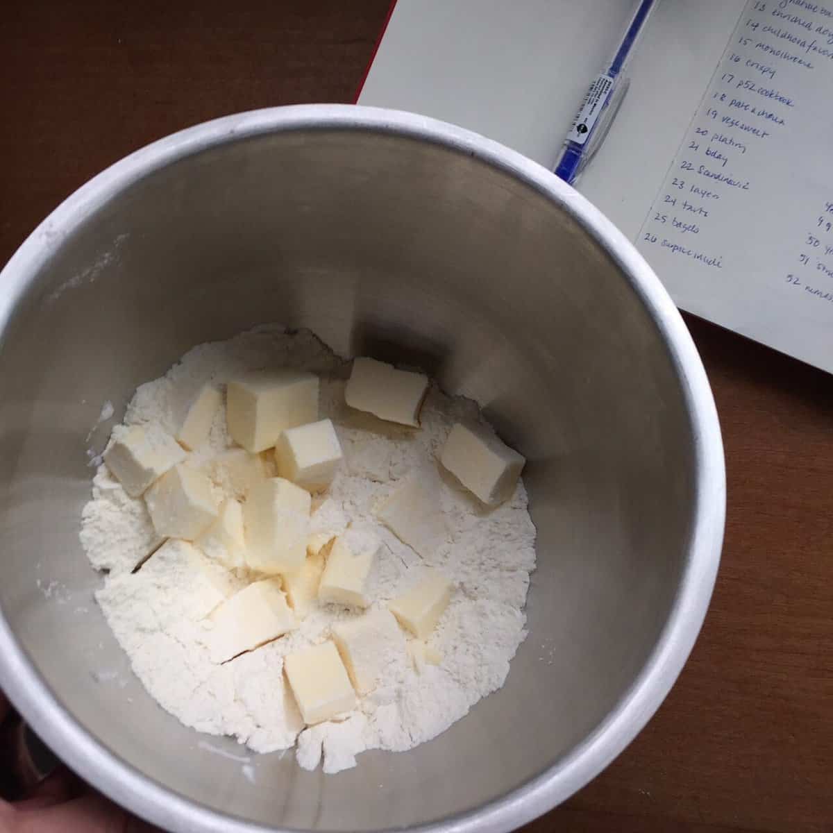 a mixing bowl of flour and butter cubes.