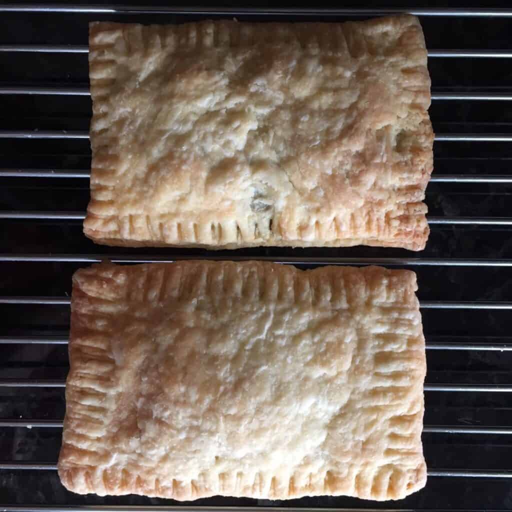 two unglazed nutella pop tarts on a cooling rack.