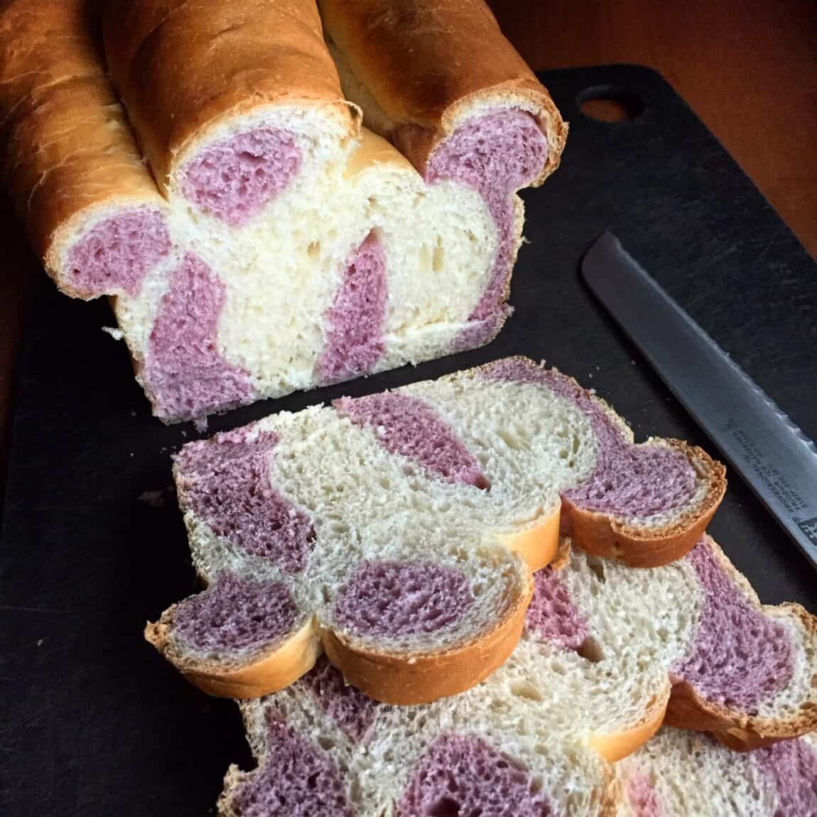 funny shaped bread with white and a mauve colored dough.
