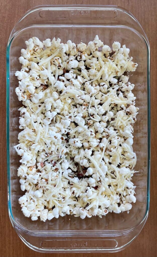 a pan of unbaked bacon cheese popcorn.