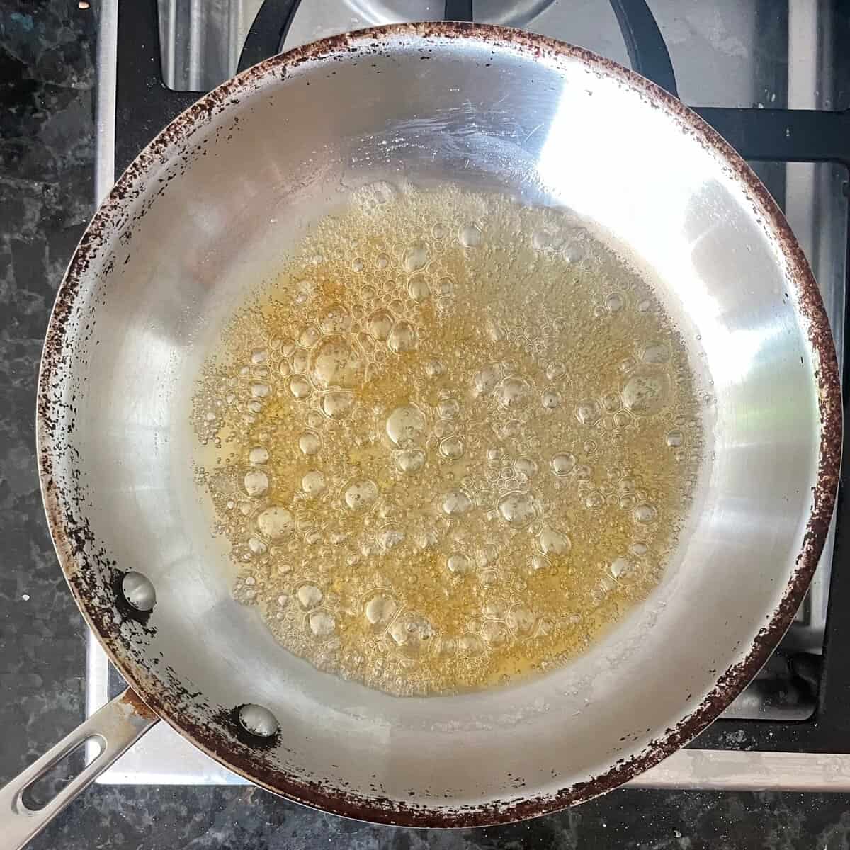 light caramel bubbling in a metal skillet.