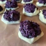 a picture of ube macaroons dipped in white chocolate