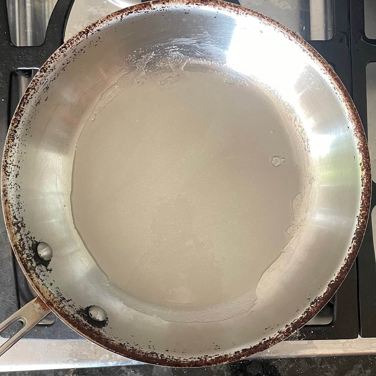 sugar and water in a frying pan.