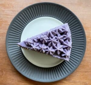 a slice of earl grey lavender cake decorated with lavender buttercream stars.
