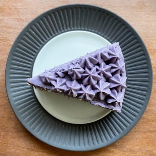 a slice of Earl Grey lavender cake with frosting piped into stars.