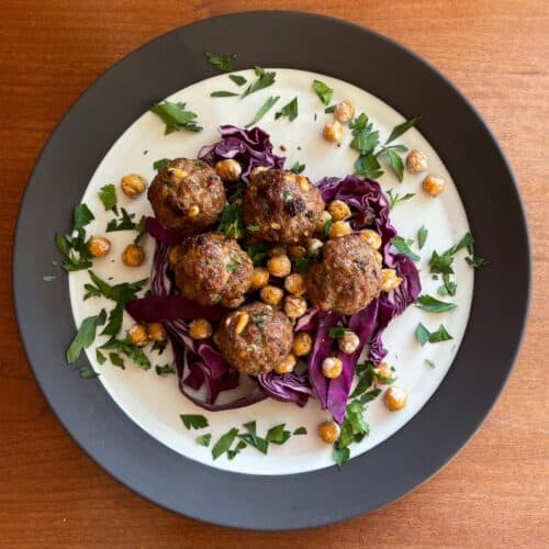 lamb meatballs with pine nuts and raisins atop fried chickpeas and purple cabbage.
