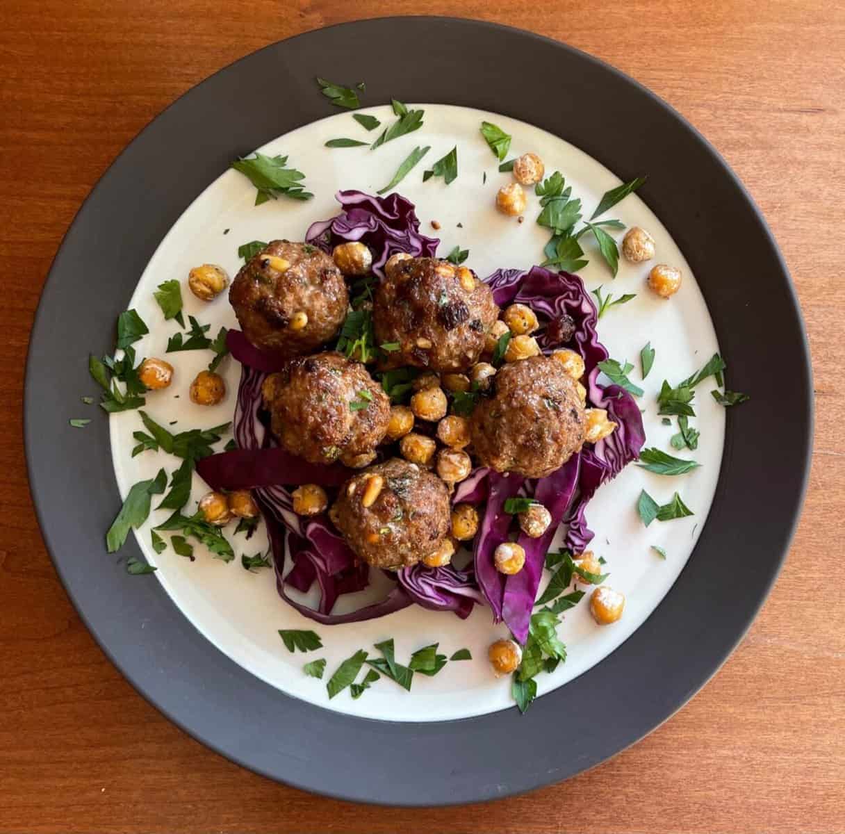 lamb meatballs with pine nuts and raisins atop fried chickpeas and purple cabbage.