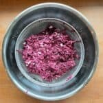 a bowl of grated purple sweet potatoes and onions