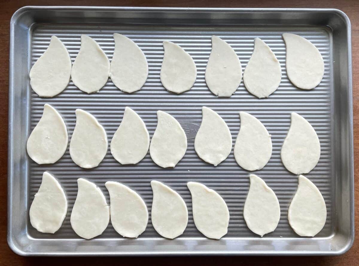 baking sheet with unbaked pie crust shaped like flower petals.