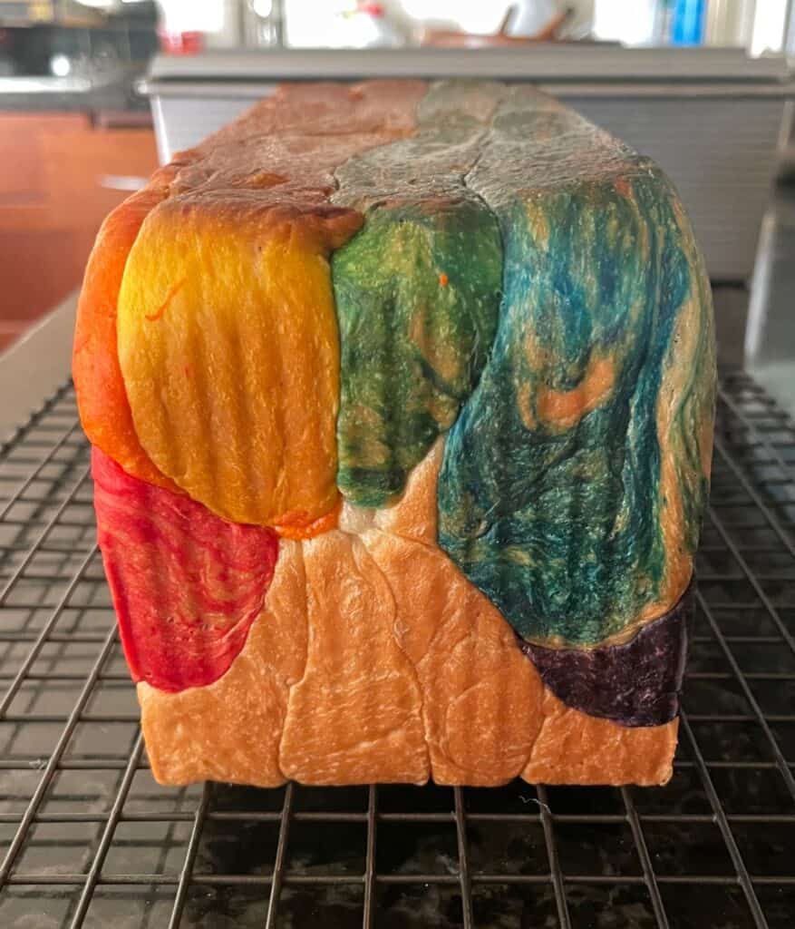 The end of a baked loaf of rainbow bread.