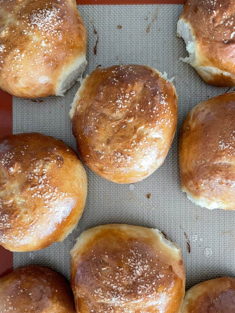 baked pretzel rolls on a baking sheet.