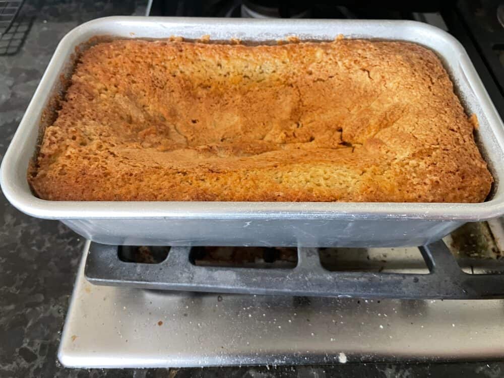 fallen loaf cake in a loaf pan.