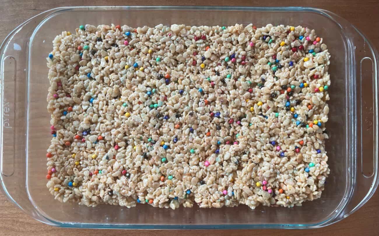 pyrex baking dish of rice krispie treats with rainbow chips.