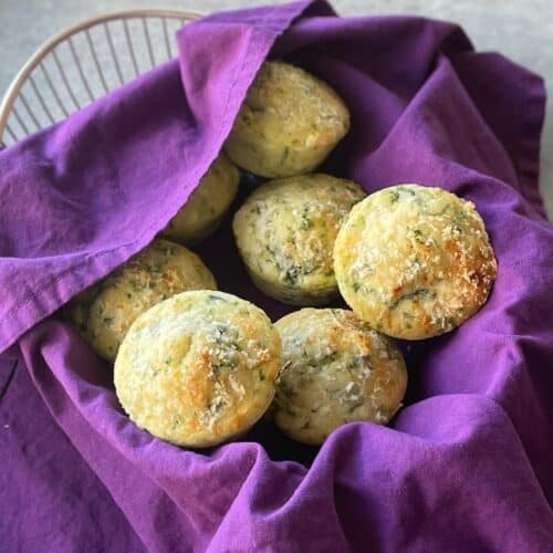 a basket filled with spinach and feta muffins.