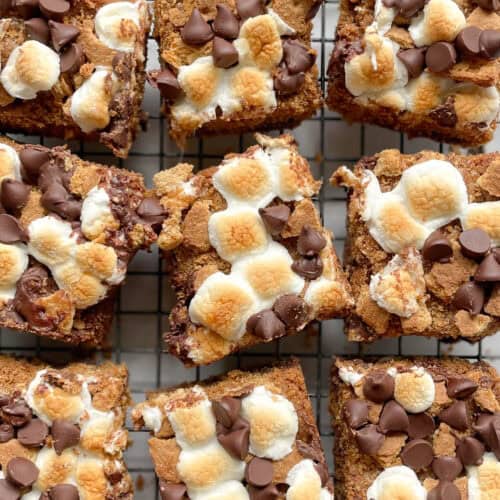 nine cut chocolate chip marshmallow cookie bars on a cooling rack.