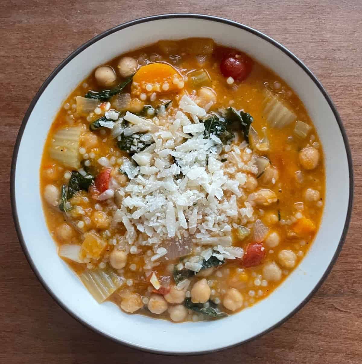 a bowl of garbanzo bean soup topped wtih Parmesan.