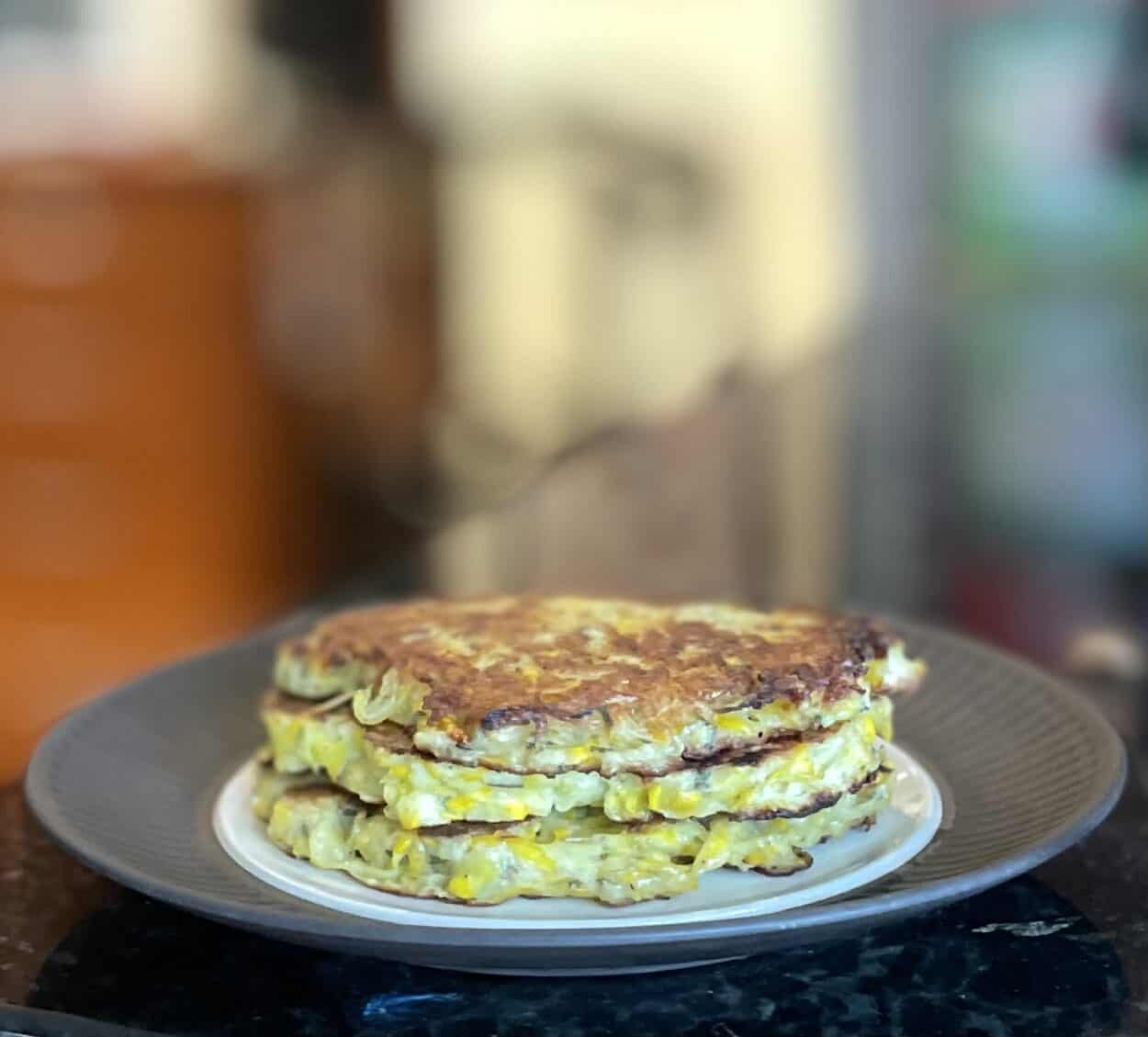 three fried patty pan squash platties stacked on a plate