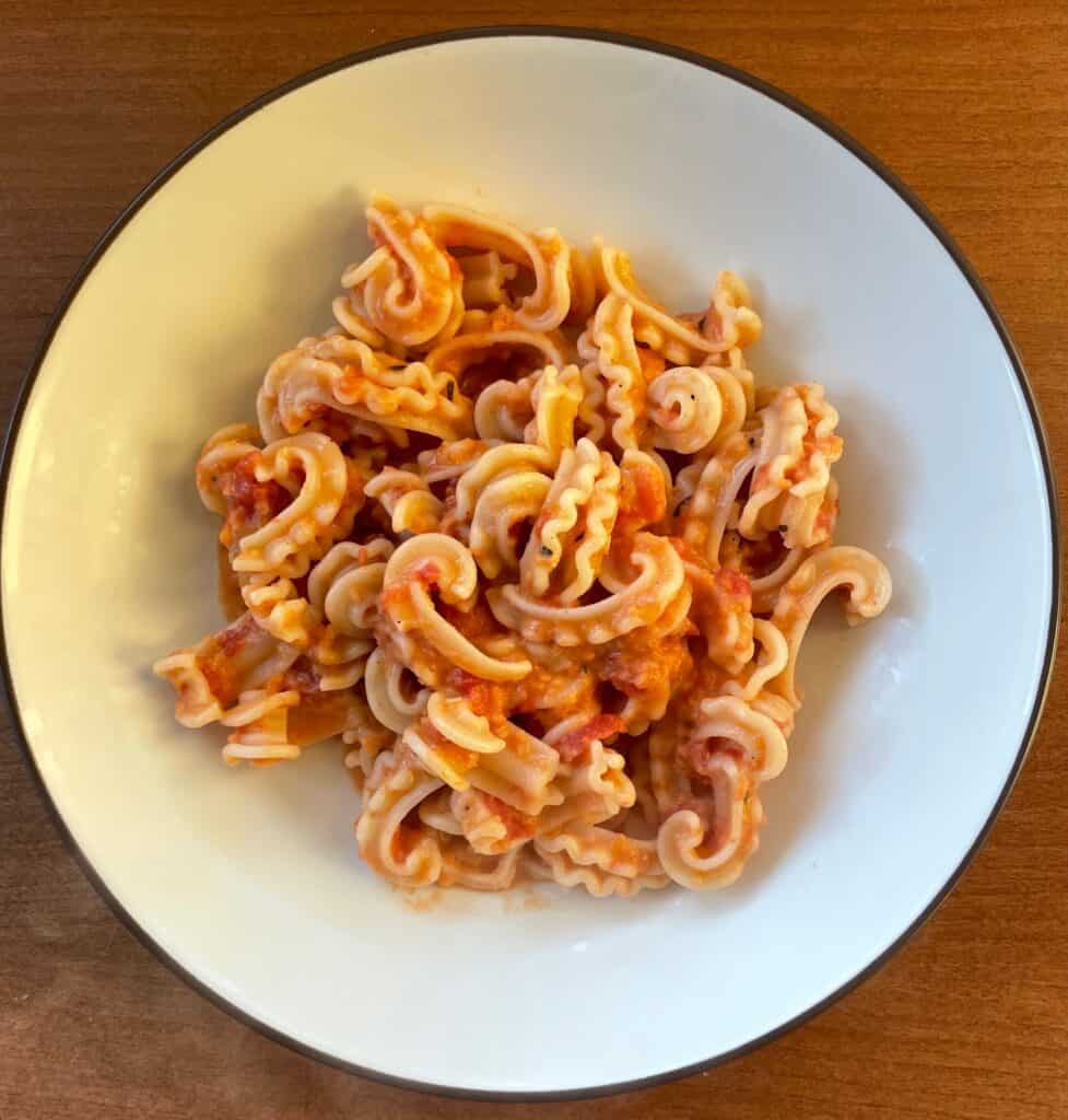 a bowl of cascatelli with pink pasta sauce.