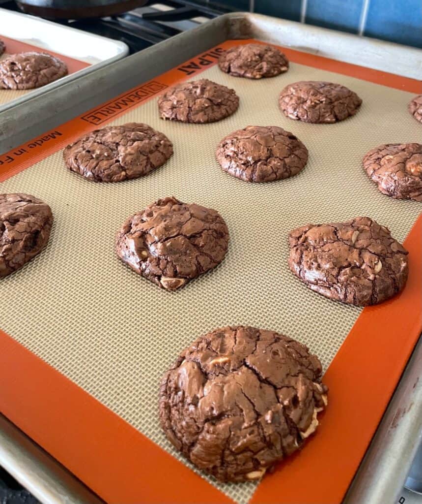 a baking sheet with baked salted caramel chip chocolate cookies.