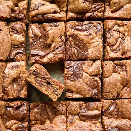 six cut blondie squares with chocolate color swirl, with one on its side.