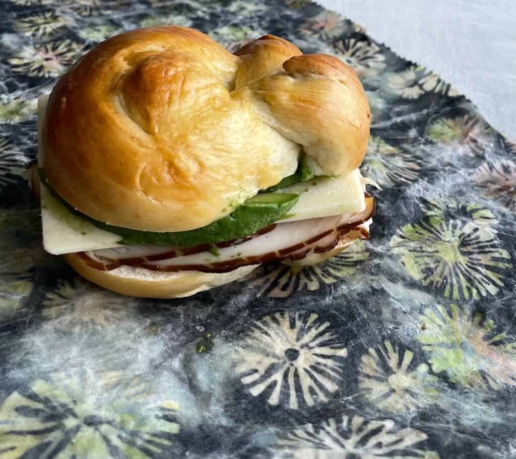 turkey and cheese sandwich on a challah bun.