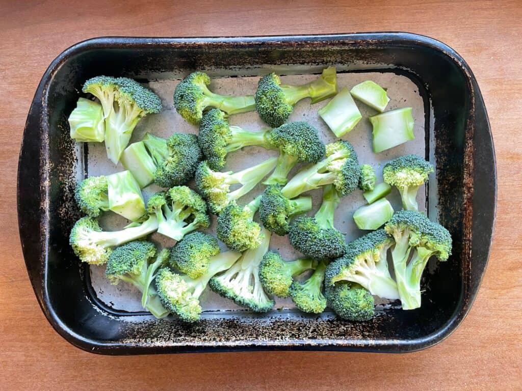 a roasting pan filled with chopped broccoli.