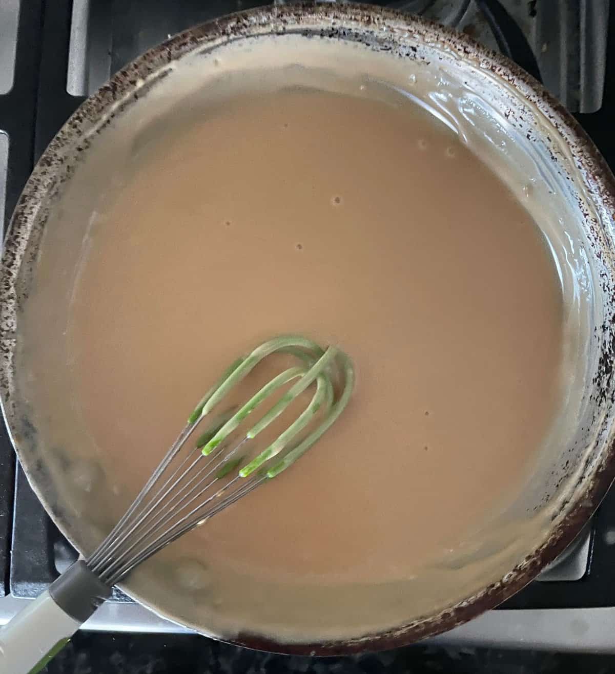 a pan of thickened salted caramel plus milk and cream.