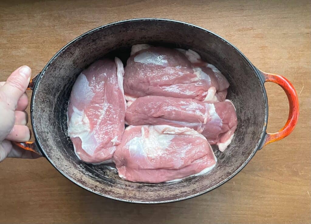 four duck breasts in a dutch oven.