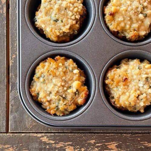 a muffin tray containing baked parmesan crusted chicken muffins.