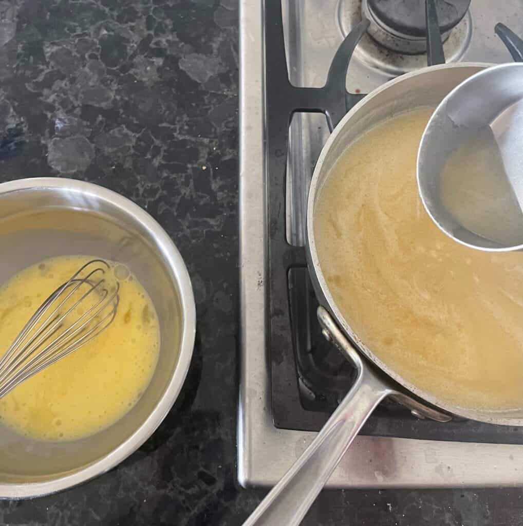 a pan of warm apple and bowl of eggs showing how to temper eggs.