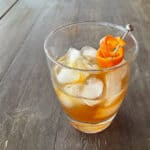 a chai bourbon old-fashioned made with honey syrup and garnished with orange peel.