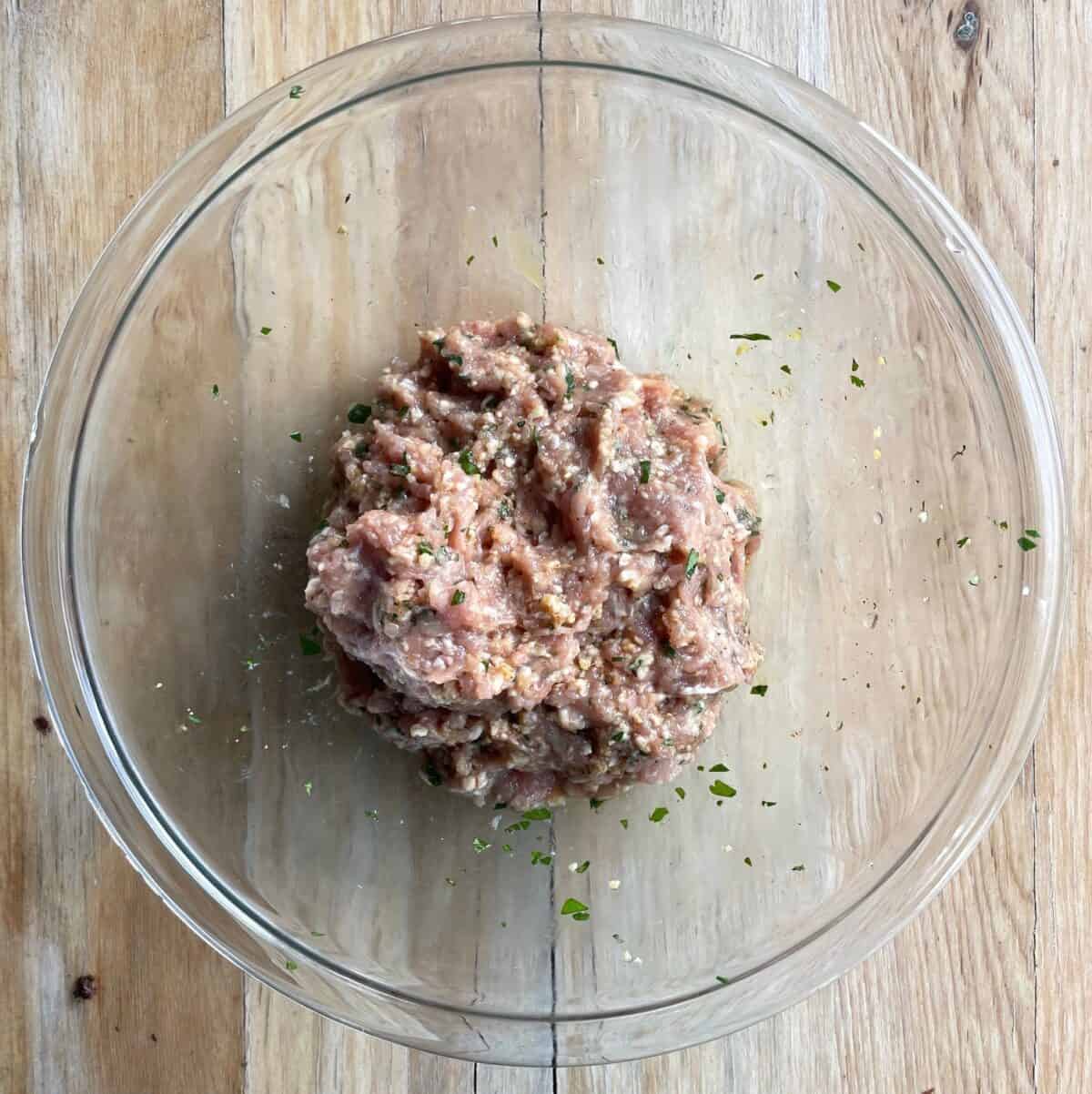 chicken meatball mixture in a glass bowl.
