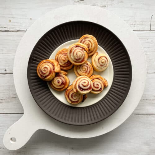 swirled cookies on a plate on a white serving tray.