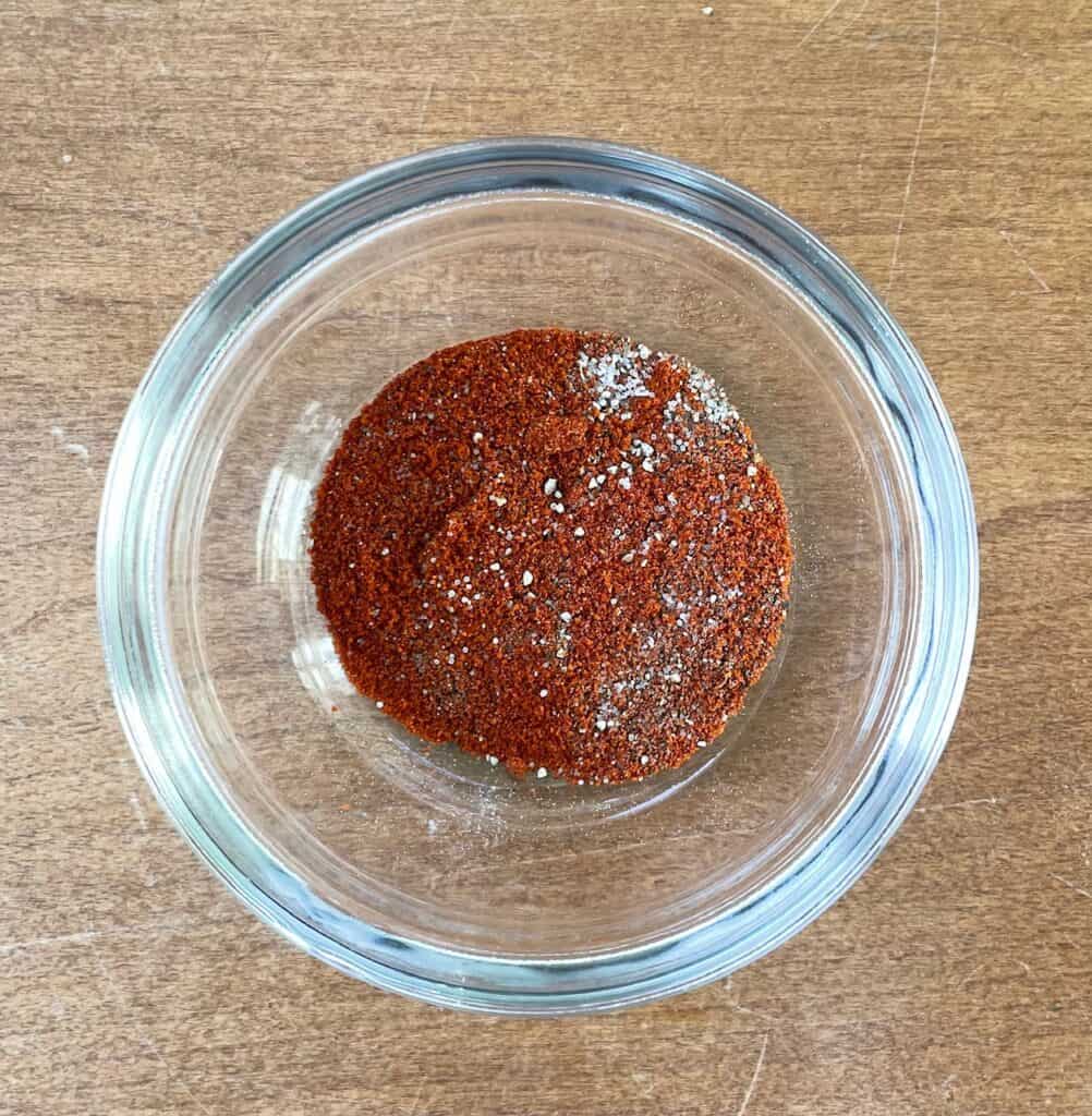 a glass bowl filled with a red spice mixture.