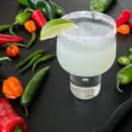 a spicy margarita surrounded by colorful chili peppers.