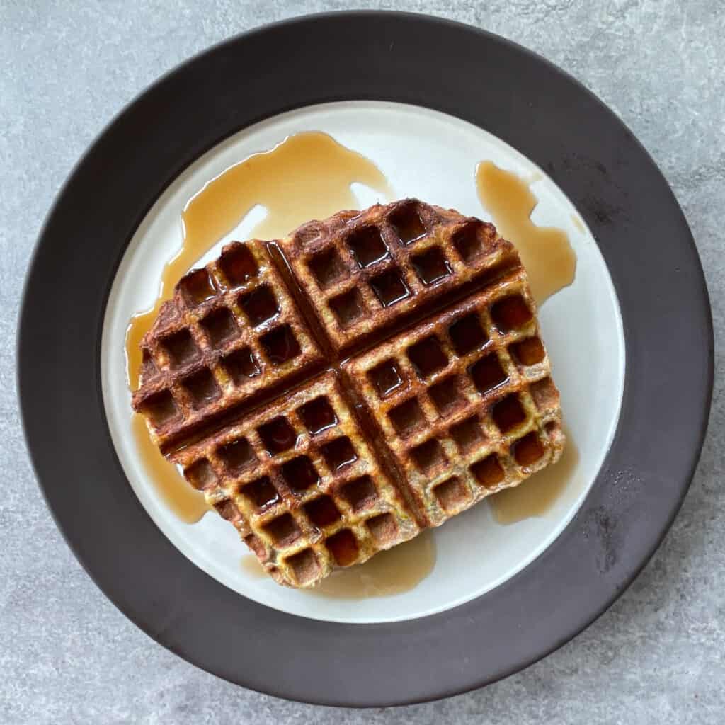 waffled french toast on a plate with syrup.