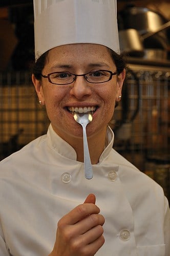 joanne stekler wearing a toque with a spoon in her mouth.