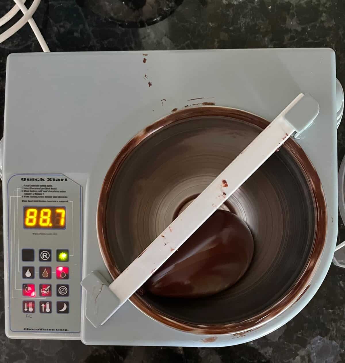 chocolate tempering machine filled with tempered chocolate.