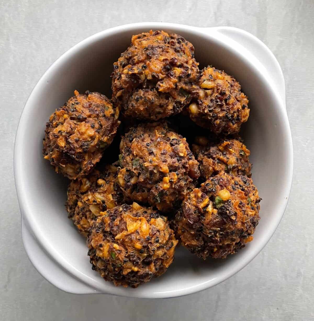 baked quinoa balls in a small bowl.