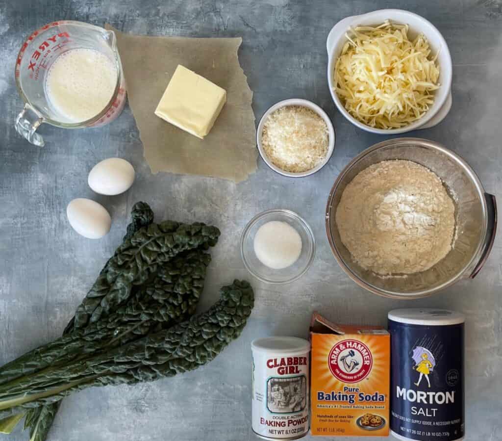 ingredients to make the kale and cheddar cheese quick bread laid out on a countertop.