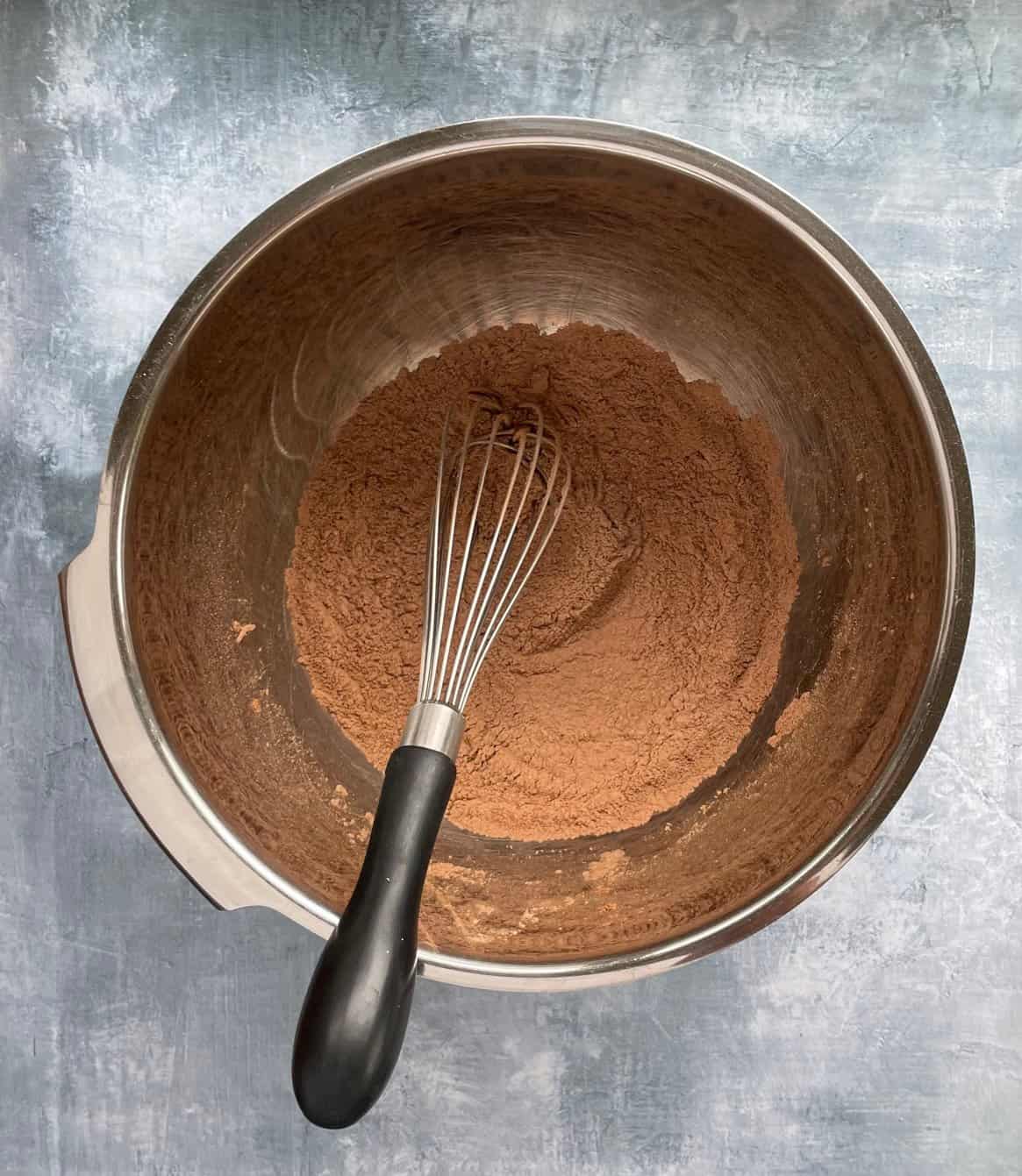brown-colored dry ingredients in a small bowl with a whisk.