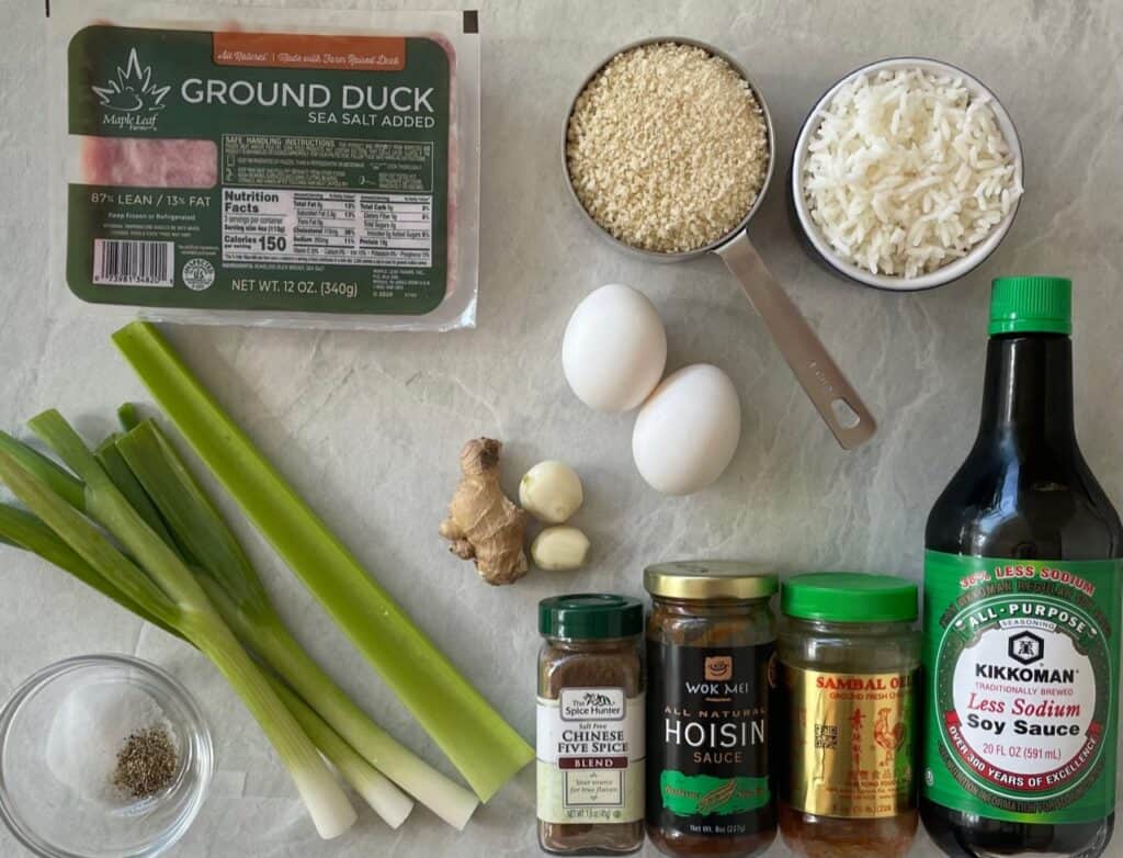 ground duck and other ingredients for duck meatloaf on a countertop.