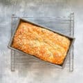 baked kale and cheese quick bread in the pan on a cooling rack.